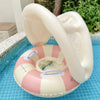 Bouée gonflable enfant rose avec canopy au bord de la piscine extérieure - Bébé Lova
