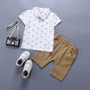 Ensemble 2 pièces garçon polo blanc à ancres et short beige présenté à plat - Bébé Lova