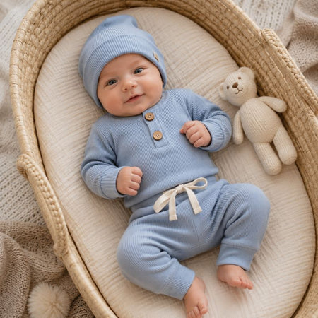 Bébé en couffin vêtu de l'ensemble côtelé bleu, body manches longues et pantalon - Bébé Lova