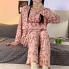 Ensemble pyjama allaitement 2 pièces rose motif léopard porté assis sur un lit - Bébé Lova