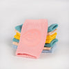 Genouillère bébé rose avec assortiment de couleurs pastel en arrière-plan - Bébé Lova
