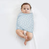 Bébé emmailloté dans un lange à motif gouttes de pluie sur fond bleu - Bébé Lova