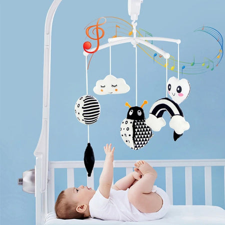 Bébé allongé dans son berceau observant une boîte à musique noir et blanc à contraste élevé avec animaux suspendus - Bébé Lova