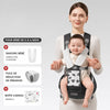 Porte-bébé KangaBaby coloris anthracite porté par une maman, avec les accessoires bavoirs, puce et boîte cadeau offerts - Bébé Lova