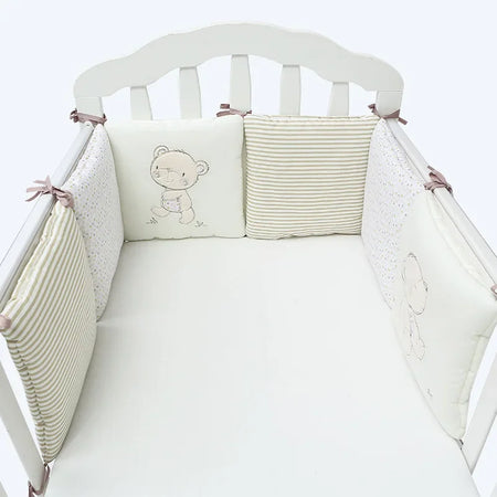 Protège-barreaux bébé beige avec motifs oursons et rayures dans un lit blanc - Bébé Lova