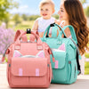Sac à dos à langer rose et vert d'eau avec maman et bébé en extérieur - Bébé Lova