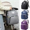 Sac à langer gris fixé à une poussette, décliné en coloris noir, marine et violet - Bébé Lova
