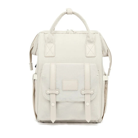 Sac à langer beige présenté de face avec poche avant à boucles - Bébé Lova