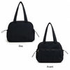 Sac à langer sport noir imperméable présenté de face et de dos sur fond clair - Bébé Lova