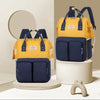 Sac à langer à dos coloris jaune et bleu marine présenté sous deux angles - Bébé Lova