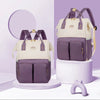 Sac à langer à dos coloris violet et crème présenté sous deux angles - Bébé Lova