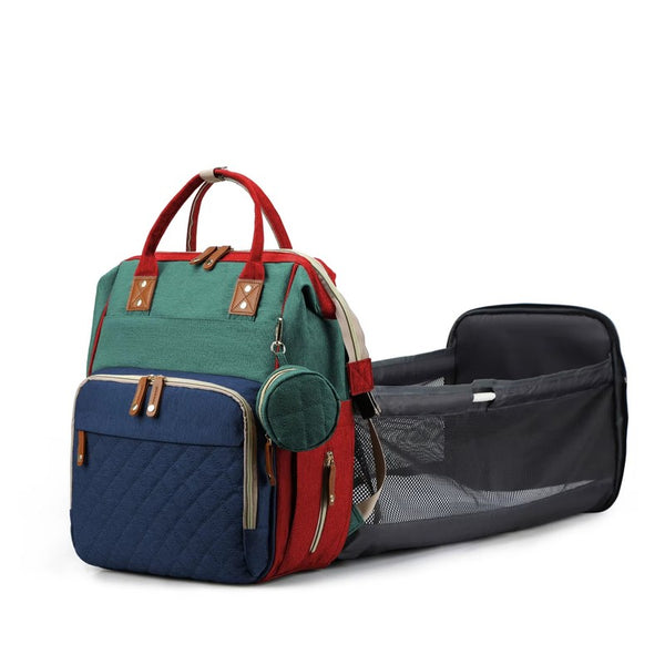 Sac à langer de voyage tricolore vert, marine et rouge avec station à langer dépliée - Bébé Lova
