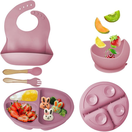 Set complet de vaisselle bébé en silicone rose : bavoir, bol à ventouse, assiette compartimentée, cuillère et fourchette à manche bois - Bébé Lova