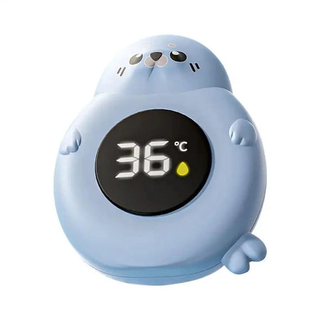 Thermomètre de bain bébé en forme de phoque bleu vu de face affichant 36°C - Bébé Lova